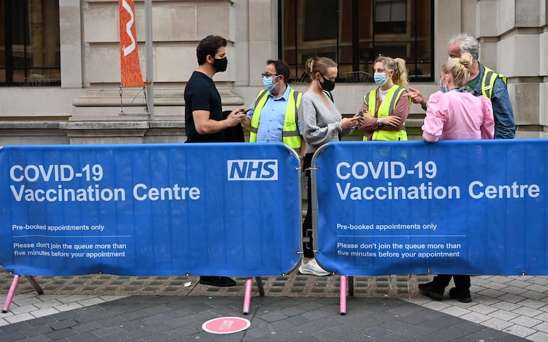 People enter a Covid-19 vaccination centre in London. EPA