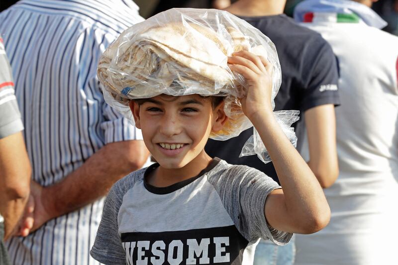A young boy leaves a bakery with a bag of bread in Lebanon's southern city of Sidon. AFP