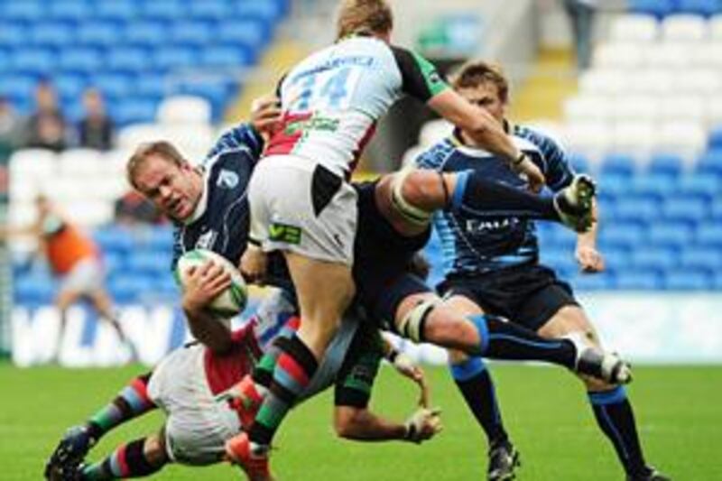 The Cardiff Blues' Xavier Rush is airborne as he is tackled by the Harlequins' Gonzalo Tiesi and David Strettle (14) yesterday.