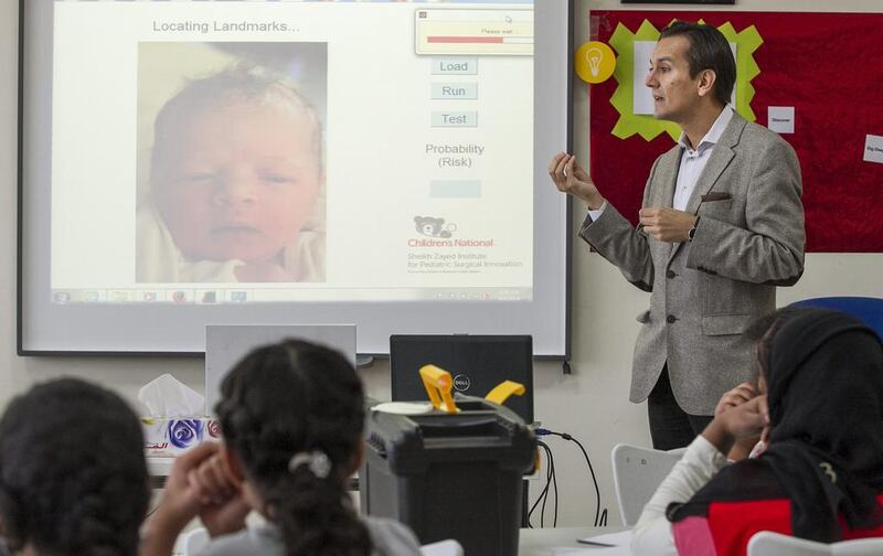 Dr Marius Linguraru, a principal investigator in the Bioengineering Initiative at Sheikh Zayed Institute for Paediatric Surgical Innovation, speaks during TechQuest’s healthcare module at the Applied Technology High School in Mohammed bin Zayed City last week. Mona Al Marzooqi / The National