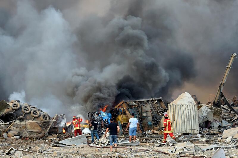 Firefighters try to extinguish flames after a large explosion rocked the harbour area of Beirut.  EPA