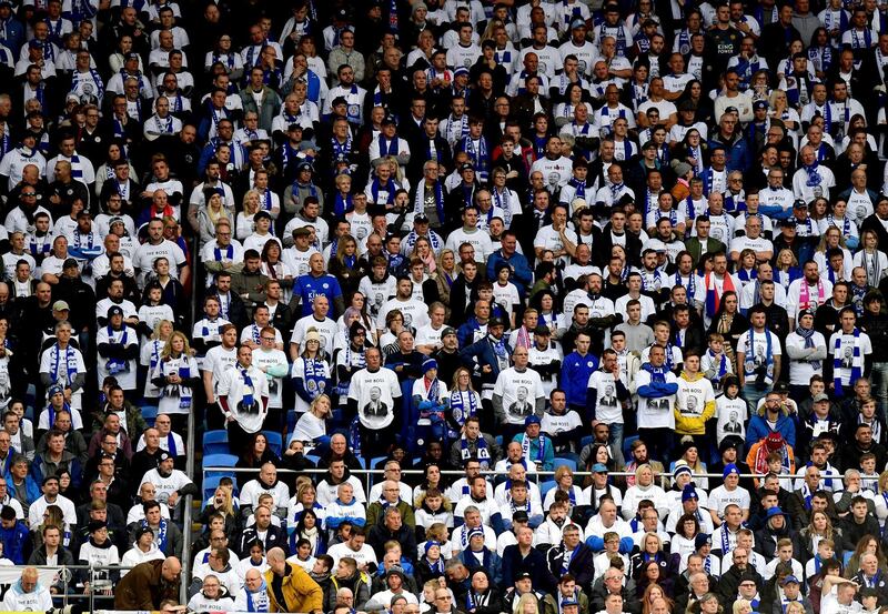 Leicester City fans in the stands wearing Vichai Srivaddhanaprabha shirts during the English Premier League soccer match between Cardiff City and Leicester City at the Cardiff City Stadium, Cardiff. Wales. AP