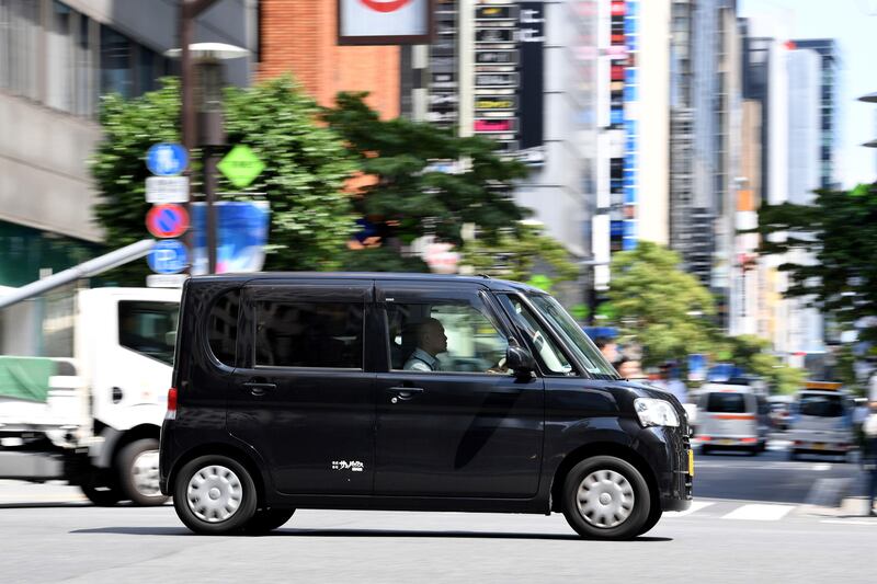 This picture taken on July 20, 2017 shows a kei, or light car in Japanese, in the the Ginza shopping district in Tokyo.
Yoko Kojima loves zipping around Tokyo in her Daihatsu Tanto with its tiny wheels and pint-sized engine, but Japan's beloved 'kei cars' may have a rocky road ahead despite a legion of loyal fans. Sales of the cutesy box-shaped cars, a staple of the world's number three vehicle market, drove off a cliff after peaking at 2.27 million units in 2014. / AFP PHOTO / Toshifumi KITAMURA / TO GO WITH Japan-auto-society, FOCUS by Anne BEADE