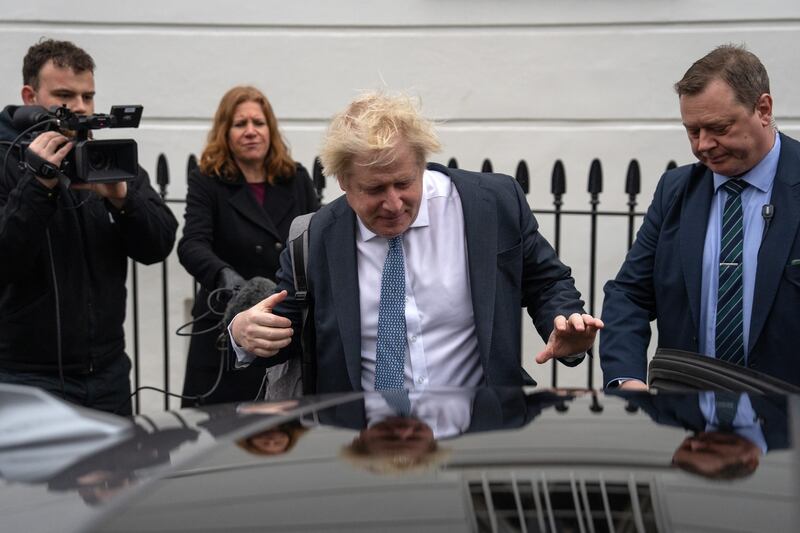 Mr Johnson leaves his home to attend a televised evidence session in March in front of the Commons Privileges Committee. Getty Images