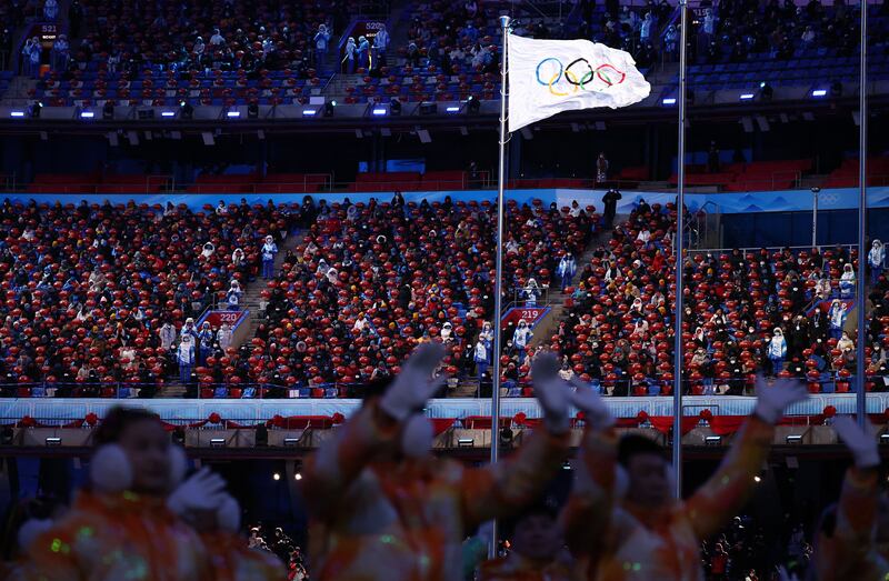 Spectators watch the closing ceremony on Sunday. Reuters