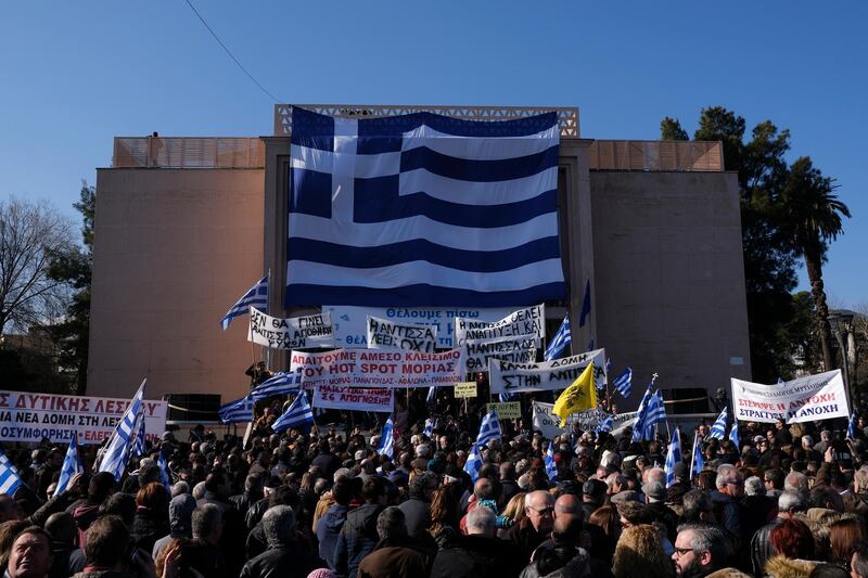 People protest outside the Municipality of Mytilene, on the northeastern Aegean island of Lesbos, Greece, on Wednesday, Jan. 22, 2020. Local residents and business owners have launched a day of protest on the Greek islands hardest hit by migration, demanding the Greek government ease severe overcrowding at refugee camps. (AP Photo/Aggelos Barai)