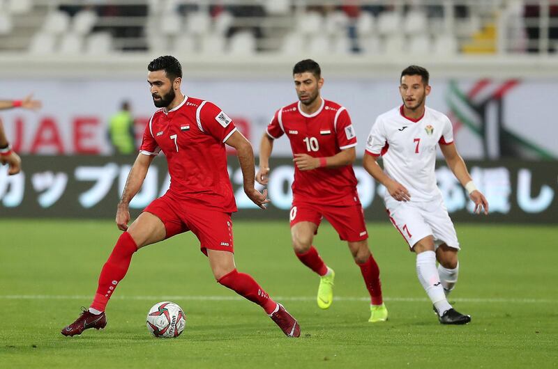 AL AIN , UNITED ARAB EMIRATES , January 10 ��� 2019 :- Omar Khrbin (  no 7 in red ) of Syria in action during the AFC Asian Cup UAE 2019 football match between Jordan vs Syria held at Sheikh Khalifa International Stadium in Al Ain. ( Pawan Singh / The National ) For News/Sports/Instagram. Story by Amith