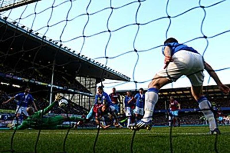 Ilan, centre, stoops to score West Ham?s second equaliser yesterday at Goodison Park.