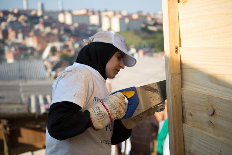 Jameela Al Baloushi an Emirati law student from Al Ain University works on a housing project, for Nadeem Hanif story on a group of volunteers from the UAE who went to a favela in Sao Paulo to help build new houses for local families, it's a project run by Monyati Initiatives, a not-for-profit social development organisation that is based in the UAE.(Photo courtesy-Amelia Johnson) *** Local Caption ***  0E1A3726.jpeg