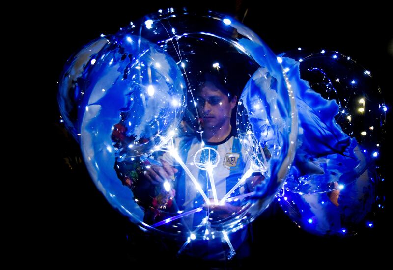 A balloon vendor is seen outside of the Argentine Football Association headquarters. Reuters