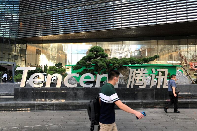 FILE PHOTO: People walk past a Tencent sign at the company headquarters in Shenzhen, Guangdong province, China August 7, 2020. REUTERS/David Kirton/File Photo