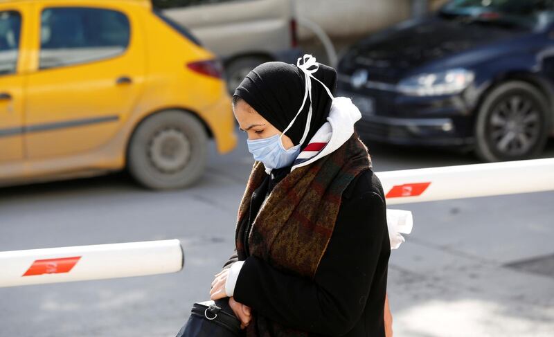 A woman wears a protective face mask as she walks in Tunis, Tunisia.  Reuters