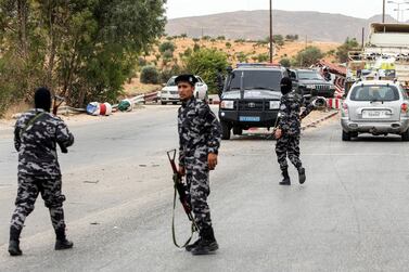 Members of security forces affiliated with the Libyan Government of National Accord (GNA)'s Interior Ministry stand at a make-shift checkpoint in the town of Tarhuna, about 65 kilometres southeast of the capital Tripoli. AFP