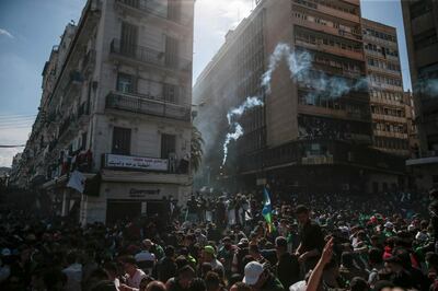 Protestors clash with police officers during a demonstration against the country's leadership, in Algiers, Friday, April 12, 2019. Heavy police deployment and repeated volleys of water cannon and tear gas didn't deter masses of Algerians from packing the streets of the capital Friday, insisting that their revolution isn't over just because the president stepped down. (AP Photo/Mosa'ab Elshamy)