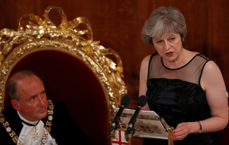FILE PHOTO: Britain's Prime Minister Theresa May makes a speech at the Lord Mayor's Banquet at the Guildhall, as Lord Mayor of the City of London Charles Bowman listens, in London, Britain November 13, 2017.  REUTERS/Peter Nicholls/File Photo