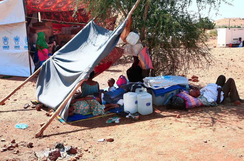 Ethiopian refugees who fled fighting in Tigray province lay in the shade by a shack at the Um Rakuba camp in Sudan's eastern Gedaref province. AFP