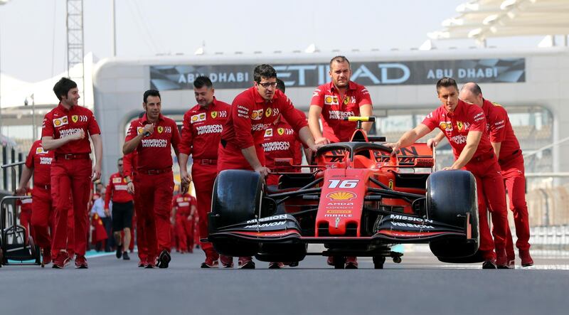 Ferrari mechanics push Charles Leclerc's car on Saturday. AP