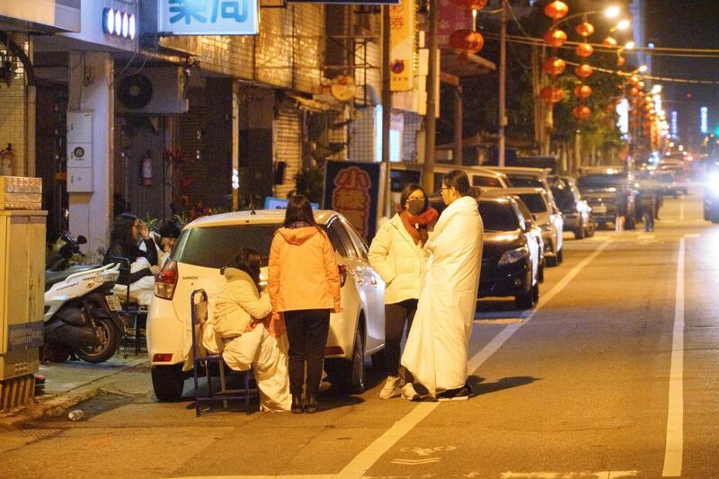 Local residents stay outside their homes in Hualien after a strong 6.4-magnitude quake rocked eastern Taiwan early on February 7, 2018. Paul Yang / AFP