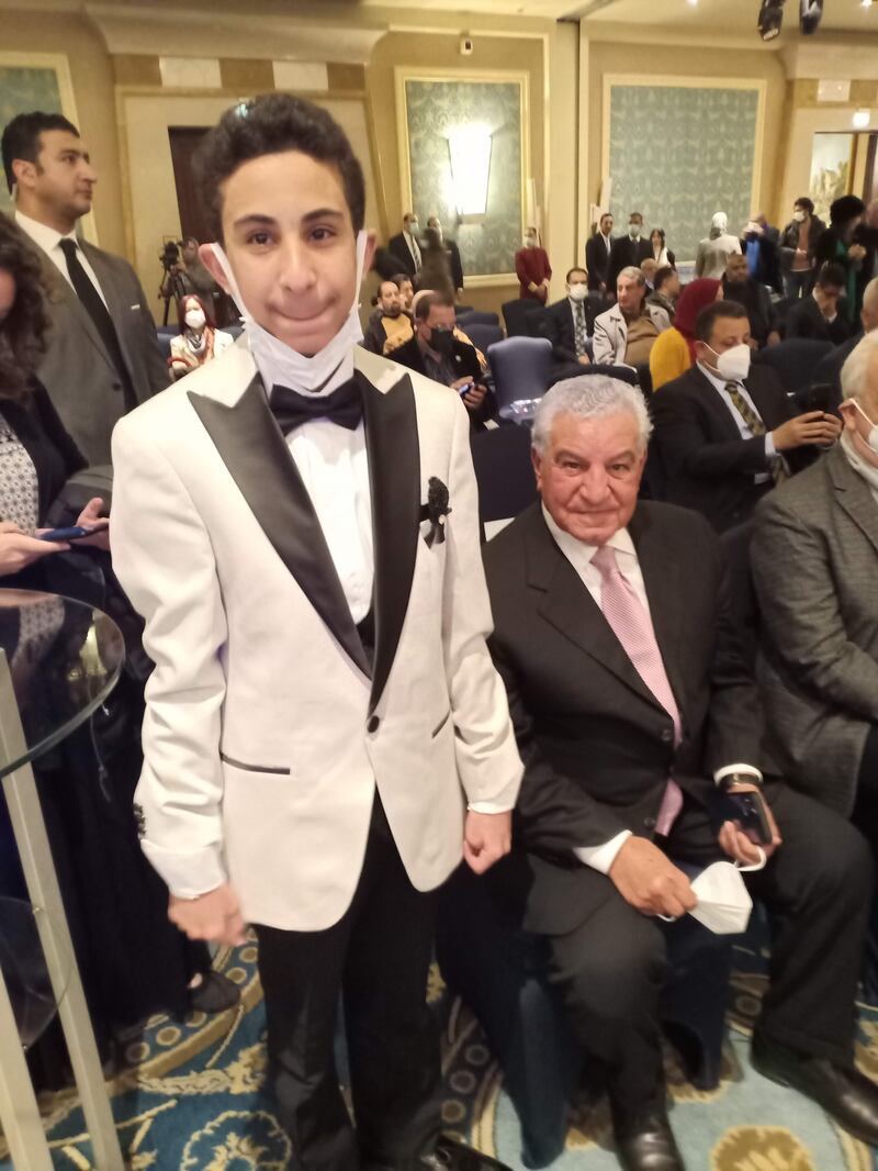 Young Egyptologist Youssef stands beside his inspiration Zahi Hawass, seated, at the event. Photo: Sami Hawas