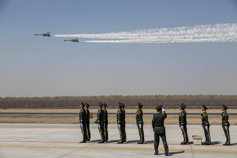 J-11 fighter jets of Chinese Air Force fly past soldiers at an airport in Shenyang, Liaoning province, China. Reuters