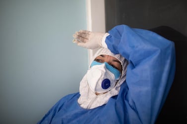 A doctor takes a break from administering Covid-19 rapid tests at a diagnosis centre in Caracas, Venezuela,  27 August. Ariana Cubillos / AP