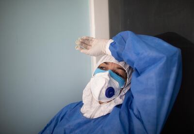 A doctor takes a break from administering COVID-19 rapid tests at a comprehensive diagnosis center that attends patients with new coronavirus in Caracas, Venezuela, Thursday, Aug. 27, 2020. (AP Photo/Ariana Cubillos)