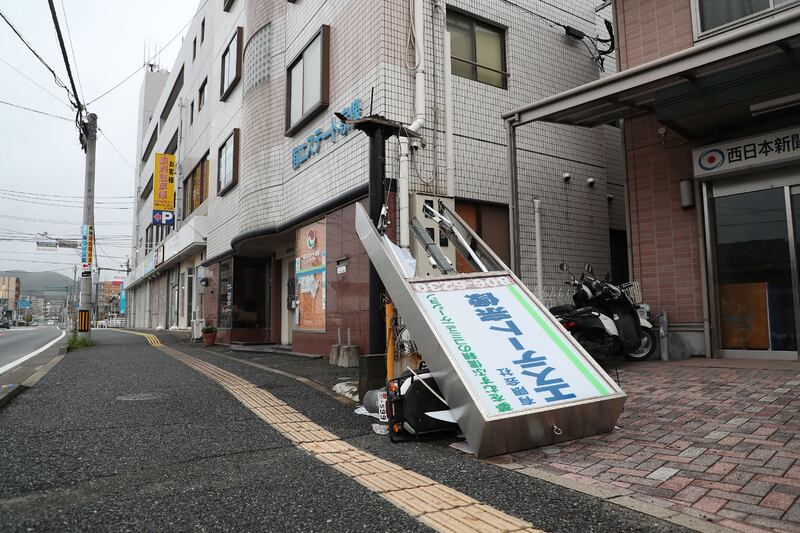 A signboard toppled on to a scooter  in south-western Japan. AFP