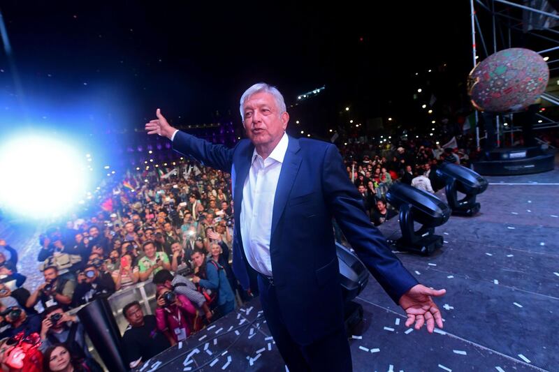 TOPSHOT - Newly elected Mexico's President Andres Manuel Lopez Obrador, running for "Juntos haremos historia" party, cheers his supporters at the Zocalo Square after winning general elections, in Mexico City, on July 1, 2018.  / AFP / PEDRO PARDO
