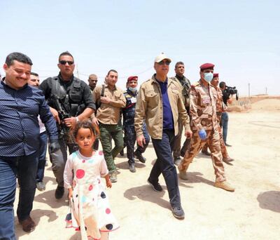 Iraqi Prime Minister Mustafa Al-Kadhimi visits one of the families who live in Al-Saidi village in Daquq district in Kirkuk governorate to check on their conditions, and calls on the security forces to protect citizens and their public and private property. Courtesy Courtesy Iraqi Prime Minister's Office