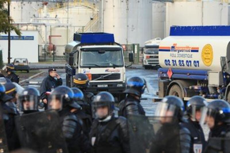 Under the protection of anti-riot police, fuel trucks leave the fuel storage depots blocked by strikers.