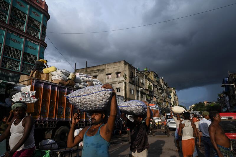 Labourers at a wholesale market in Kolkata. India's economy expanded by more than 20 per cent in the April-June quarter. AFP