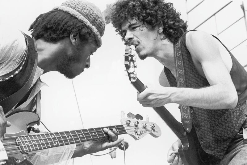 August 1969:  Mexican-born guitarist Carlos Santana (right) and bassist David Brown perform with the group Santana at the Woodstock Music Festival in Bethel, New York.  (Photo by Tucker Ransom/Hulton Archive/Getty Images)
