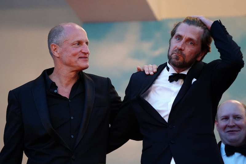 Woody Harrelson and Ruben Oestlund leave after the screening of 'Triangle of Sadness'. EPA