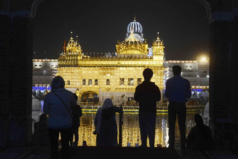 Indian Sikh devotees gather to pay their respects as lights glow on the eve of Diwali.  AFP