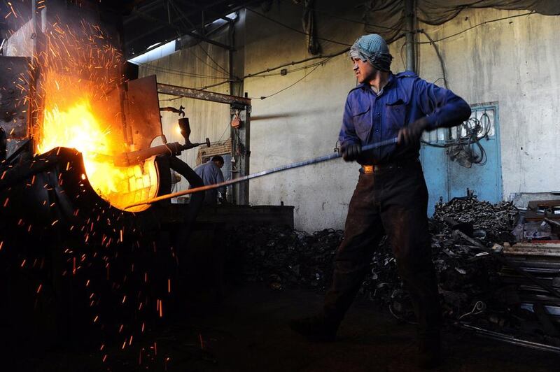 A labourer works at an aluminium workshop in Herat.