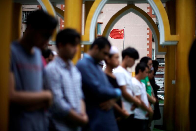A Chinese flag is seen as Muslims celebrate Eid Al Adha at a mosque in Shanghai, China.  Reuters