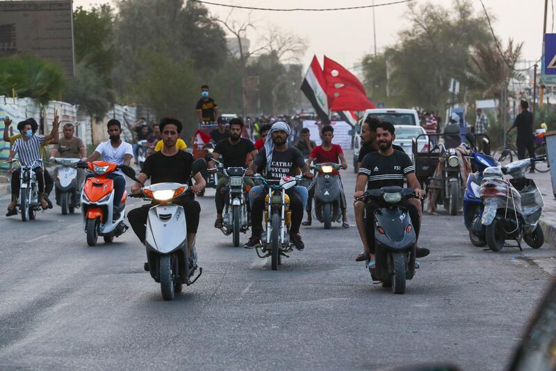 Protesters ride motorcycles during a demonstration in Basra, Iraq. AP Photo