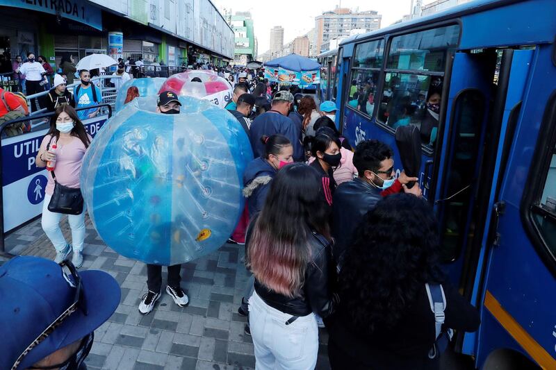 Workers at the El Gran San Shopping Center walk inside balloons as part of a campaign to maintain physical distance between shoppers during the Christmas season, in Bogota, Colombia. The South American country recently passed the unprecedented figure of 40,000 deaths from Covid-19.  EPA