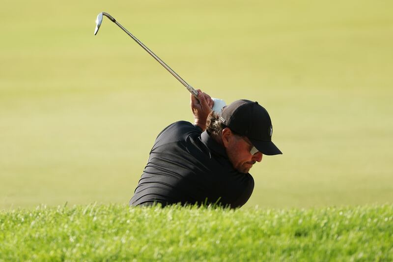 Phil Mickelson plays a shot from a bunker on the 15th hole. AFP