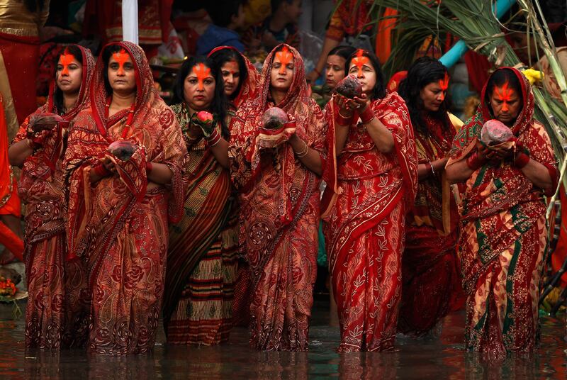 Nepalese women hold coconuts and offer prayers to the setting sun on the banks of the Bagmati River during the Chhath Puja festival in Kathmandu, Nepal. Niranjan Shrestha / AP Photo