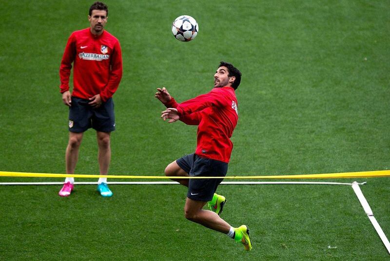 Raul Garcia, front, of Atletico Madrid  heads the ball with teammate Gabi Fernandez during the Atletico team training session on Monday in anticipation of the Champions League final. Gonzalo Arroyo Moreno / Getty Images / May 19, 2014