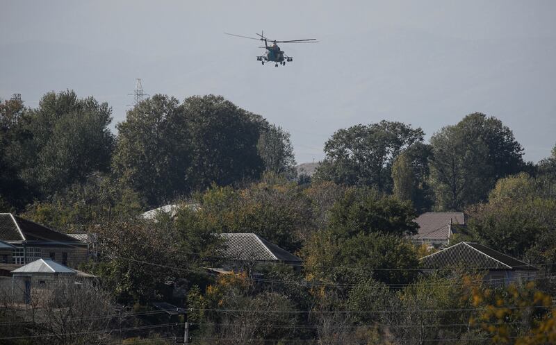 An Azerbaijani military helicopter flies near the city of Terter, Azerbaijan. Officials said 14 people died in a military helicopter crash in Caucasus. Reuters