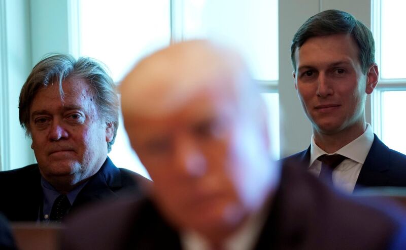 FILE PHOTO:    Trump advisers Steve Bannon (L) and Jared Kushner (R) listen as U.S. President Donald Trump meets with members of his Cabinet at the White House in Washington, U.S., June 12, 2017.  REUTERS/Kevin Lamarque/File Photo