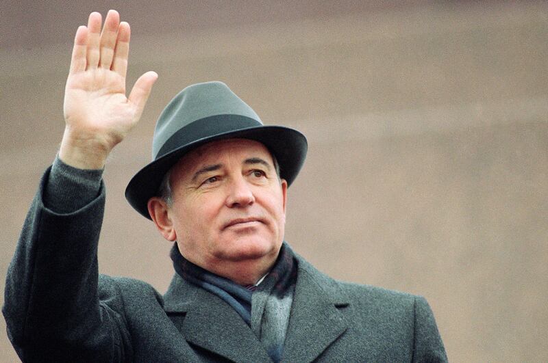 Mikhail Gorbachev waves from the Red Square in Moscow during a Revolution Day celebration in November 1989. AP