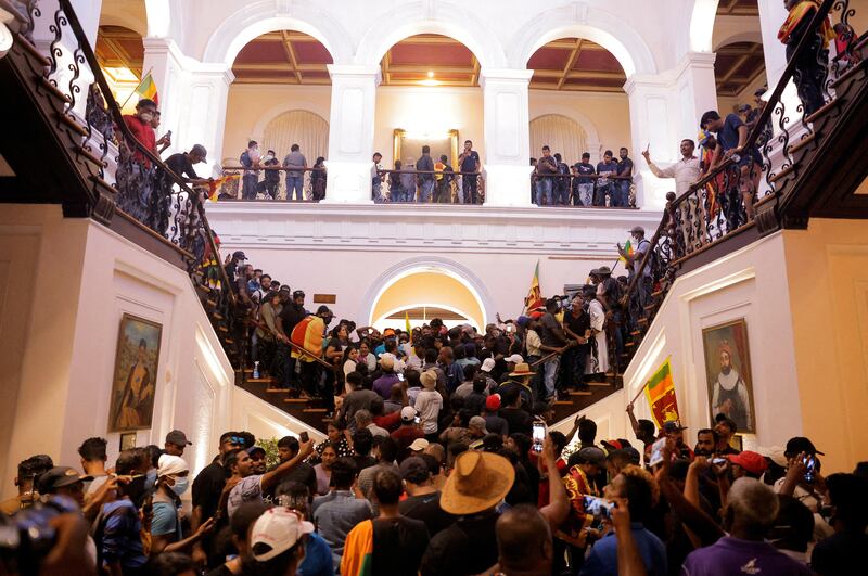 Demonstrators protest inside the house of President Gotabaya Rajapaksa after he fled amid Sri Lanka's economic crisis, on July 9. Reuters