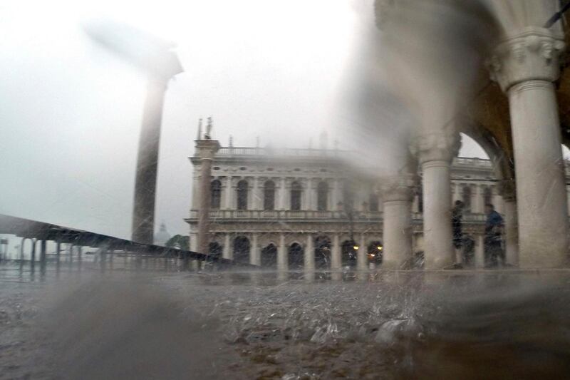 Pouring rain adds discomfort in Venice. Luca Bruno / AP Photo