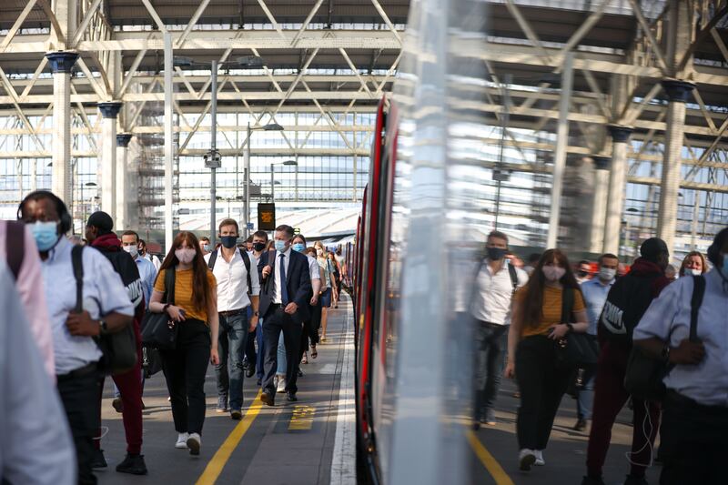 Commuters arrive at London Waterloo railway station. Most coronavirus restrictions ended in England on Monday.