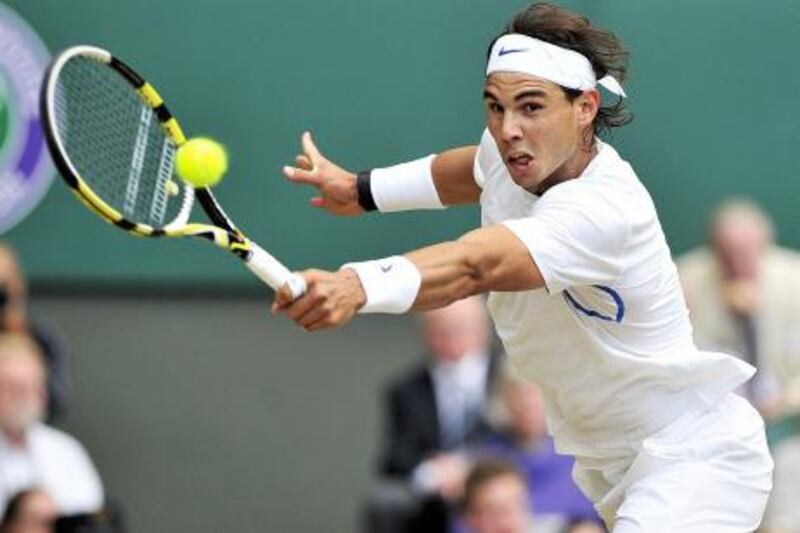 Spanish player Rafael Nadal returns a shot to British player Andy Murray during the men's single semi final at the Wimbledon Tennis Championships at the All England Tennis Club, in southwest London on July 1, 2011.  AFP PHOTO /GLYN KIRK
RESTRICTED TO EDITORIAL USE
 *** Local Caption ***  336582-01-08.jpg