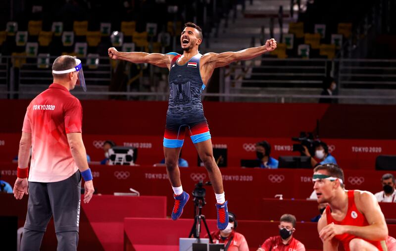 Mohamed Ibrahim Elsayed of Egypt jumps for joy after defeating Artem Surkov to win bronze in the Greco-Roman wrestling.