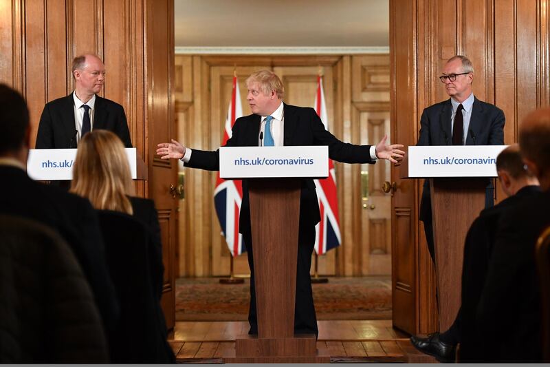 Boris Johnson, U.K. prime minister, center, speaks while Chris Whitty, U.K. chief medical officer, left, and Patrick Vallance, U.K. lead science adviser, listens during a daily coronavirus briefing inside number 10 Downing Street in London, U.K. Johnson said the U.K. can "turn the tide" on its burgeoning coronavirus outbreak within three months, as he said ministers will unveil measures to protect businesses and workers from the crisis. Getty Images